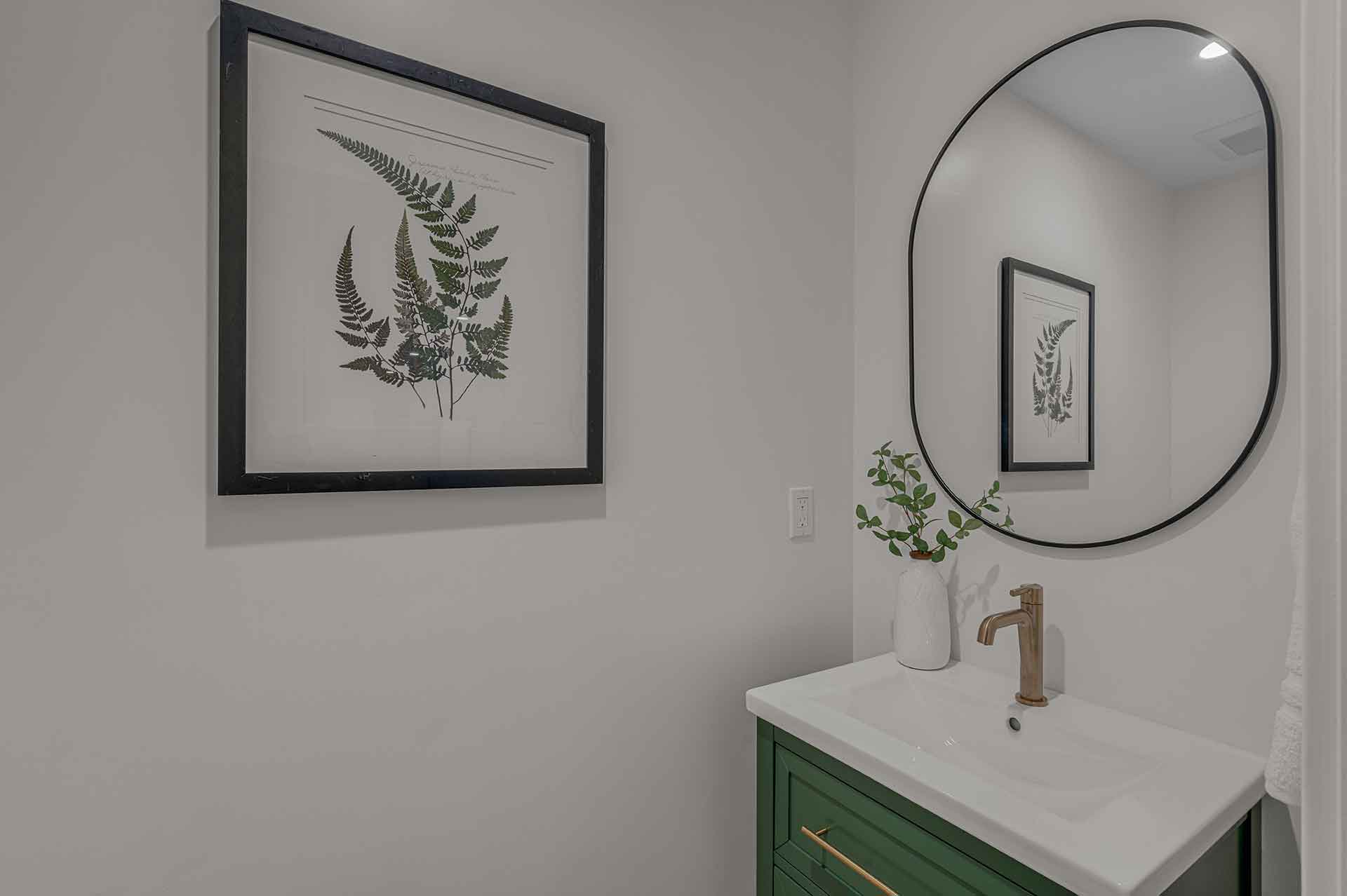 Bathroom with Green Vanity, Gold Faucet, and Fern Wall Art