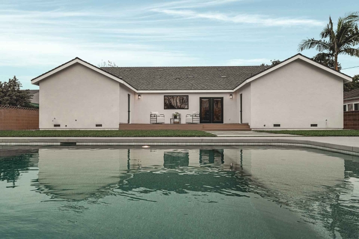 Lush Backyard Featuring a Swimming Pool and Open Lawn Area Facing the House Lush Backyard Featuring a Swimming Pool and Open Lawn Area Facing the House