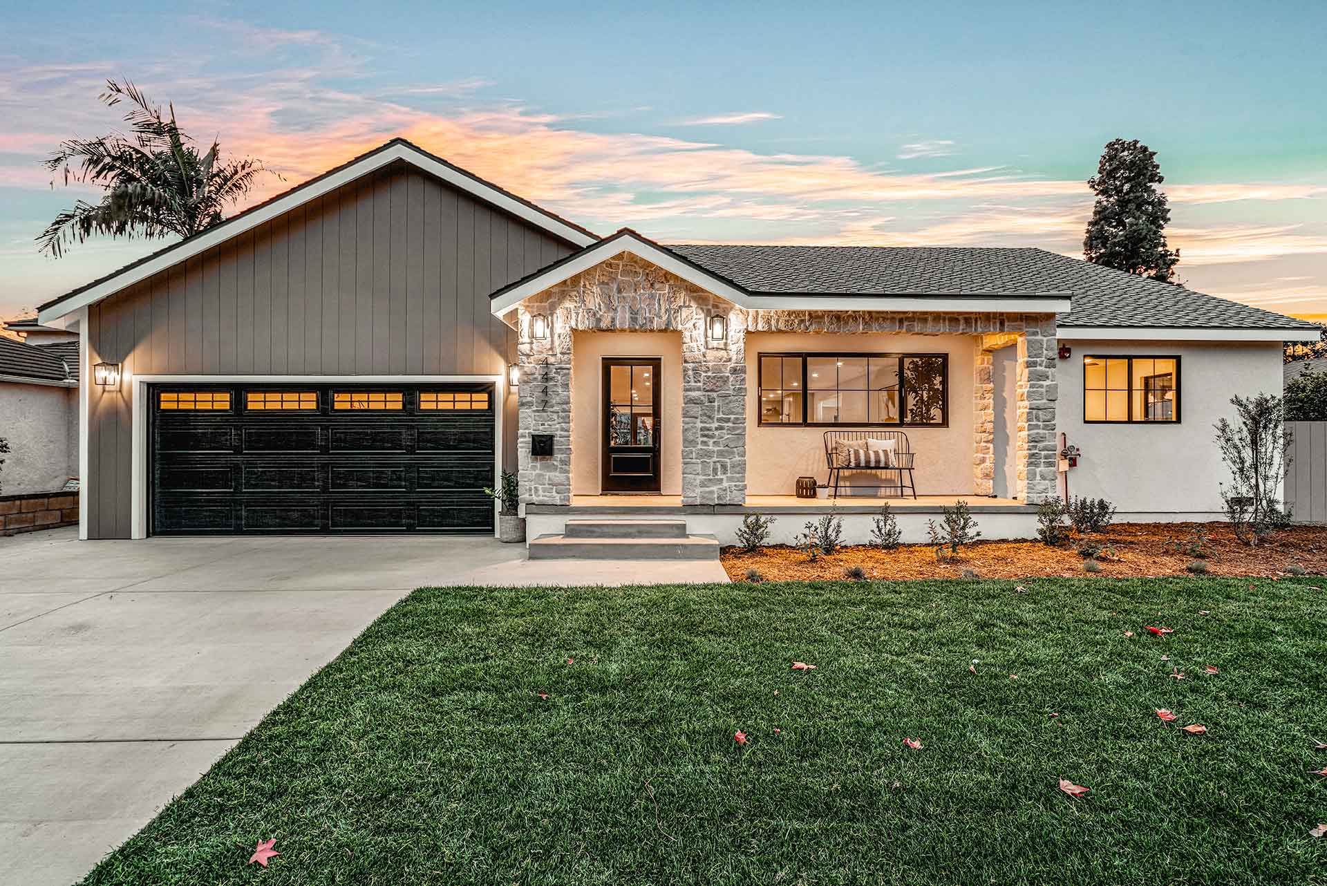 Modern Home Exterior with Stone Accents and Dark Garage Door