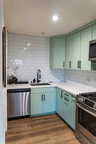 Modern ADU Kitchen with Sage Green Cabinets and White Subway Tile