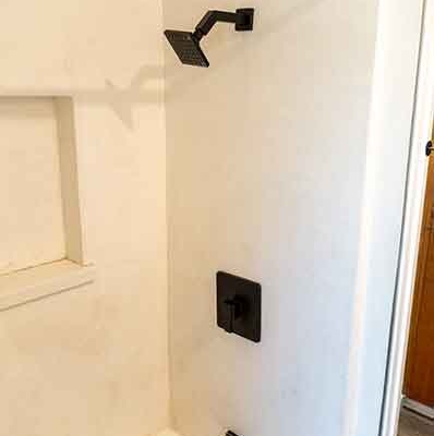 Bathtub and shower with modern matte black hardware. Bathtub and shower with modern matte black hardware.